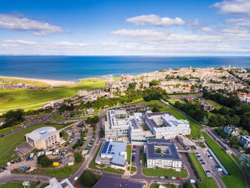Aerial photo of the University of St Andrews with the North Haugh science campus in the foreground, looking towards the sea.